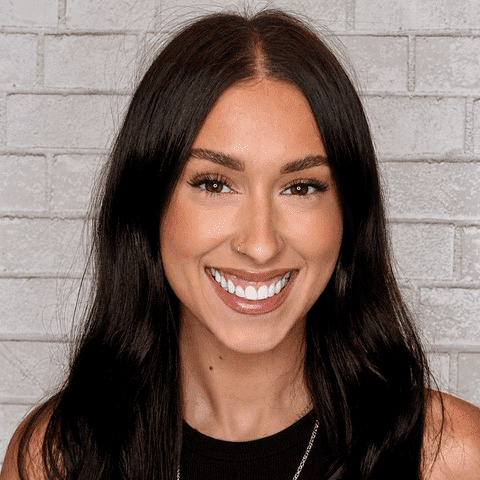 Portrait of Sydney, a professional stylist at Hudson Salon, showcasing their expertise and style.