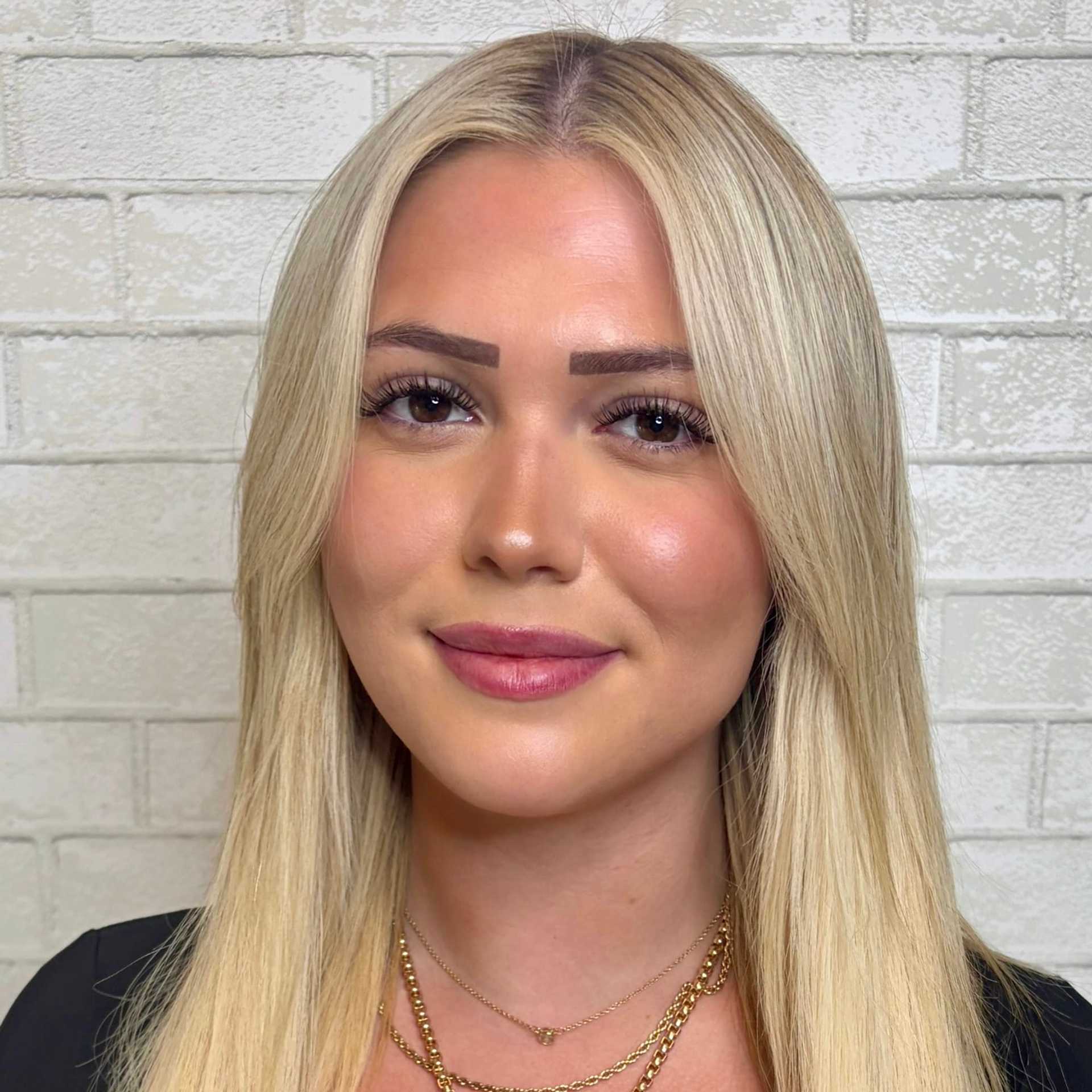 Portrait of Makayla, a professional stylist at Hudson Salon, showcasing their expertise and style.