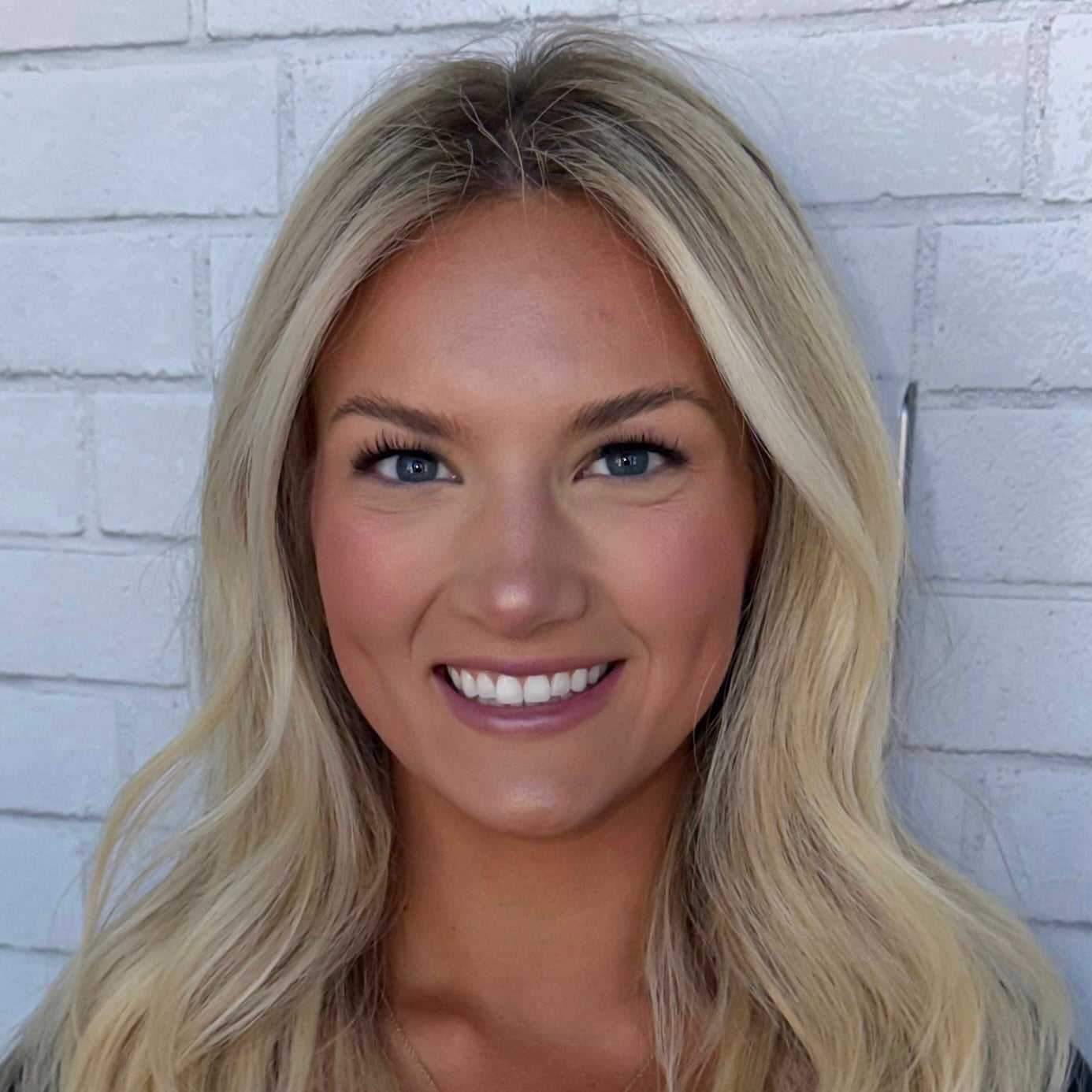 Portrait of Julia, a professional stylist at Hudson Salon, showcasing their expertise and style.