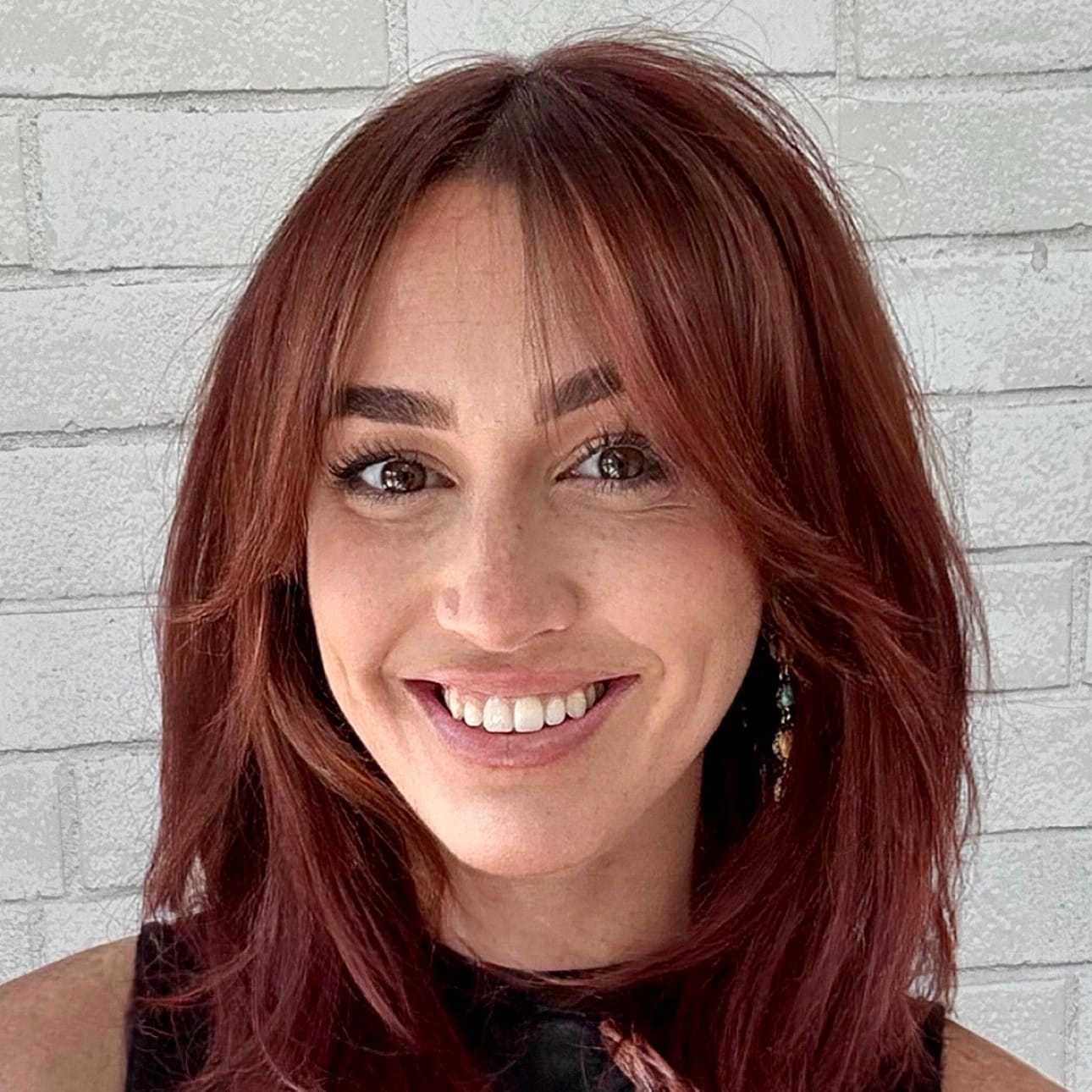 Portrait of Tess, a professional stylist at Hudson Salon, showcasing their expertise and style.