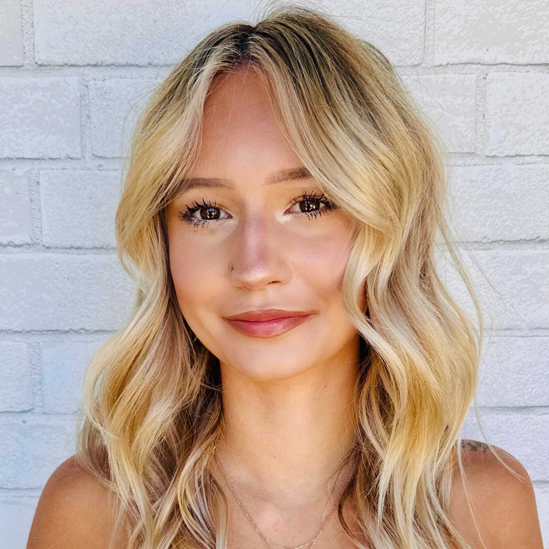 Portrait of Sam, a professional stylist at Hudson Salon, showcasing their expertise and style.
