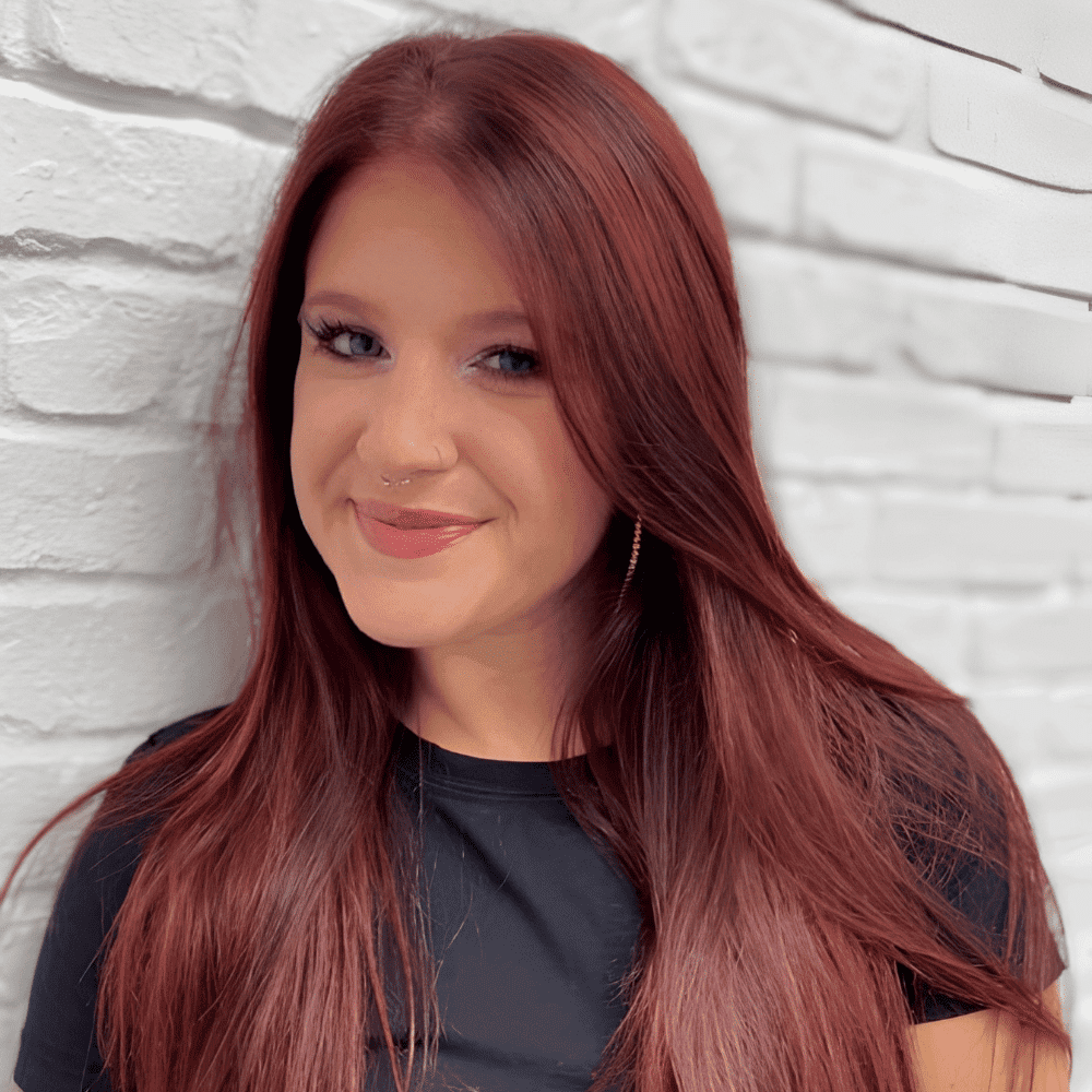 Portrait of Kyli, a professional stylist at Hudson Salon, showcasing their expertise and style.