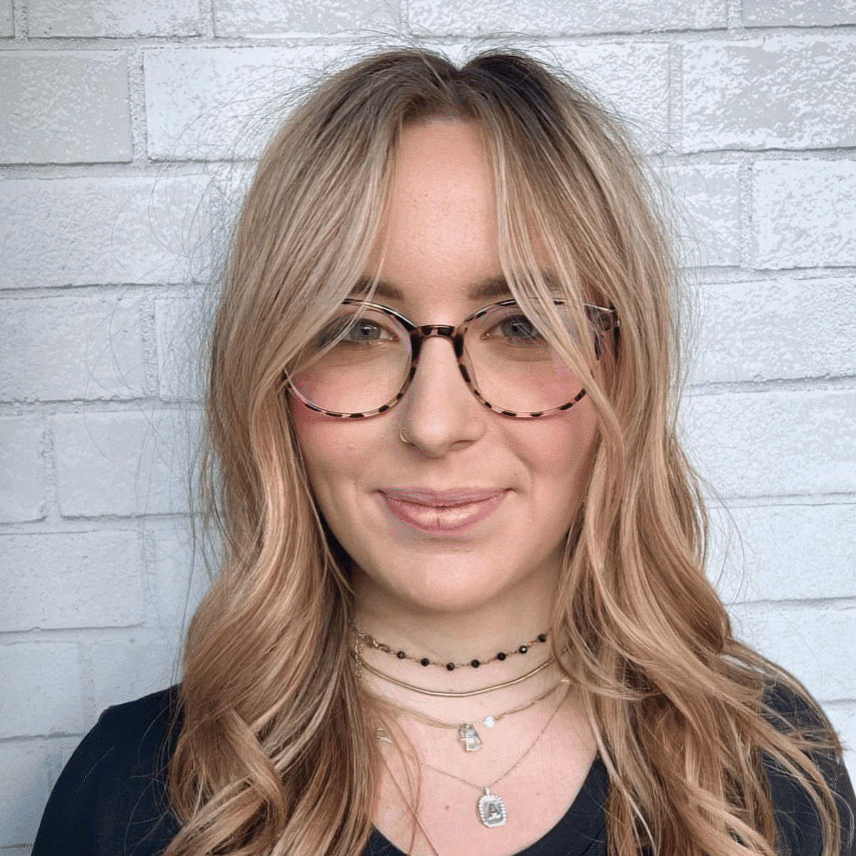Portrait of Anna, a professional stylist at Hudson Salon, showcasing their expertise and style.