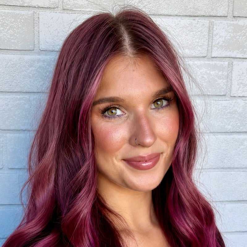 Portrait of Jessie, a professional stylist at Hudson Salon, showcasing their expertise and style.