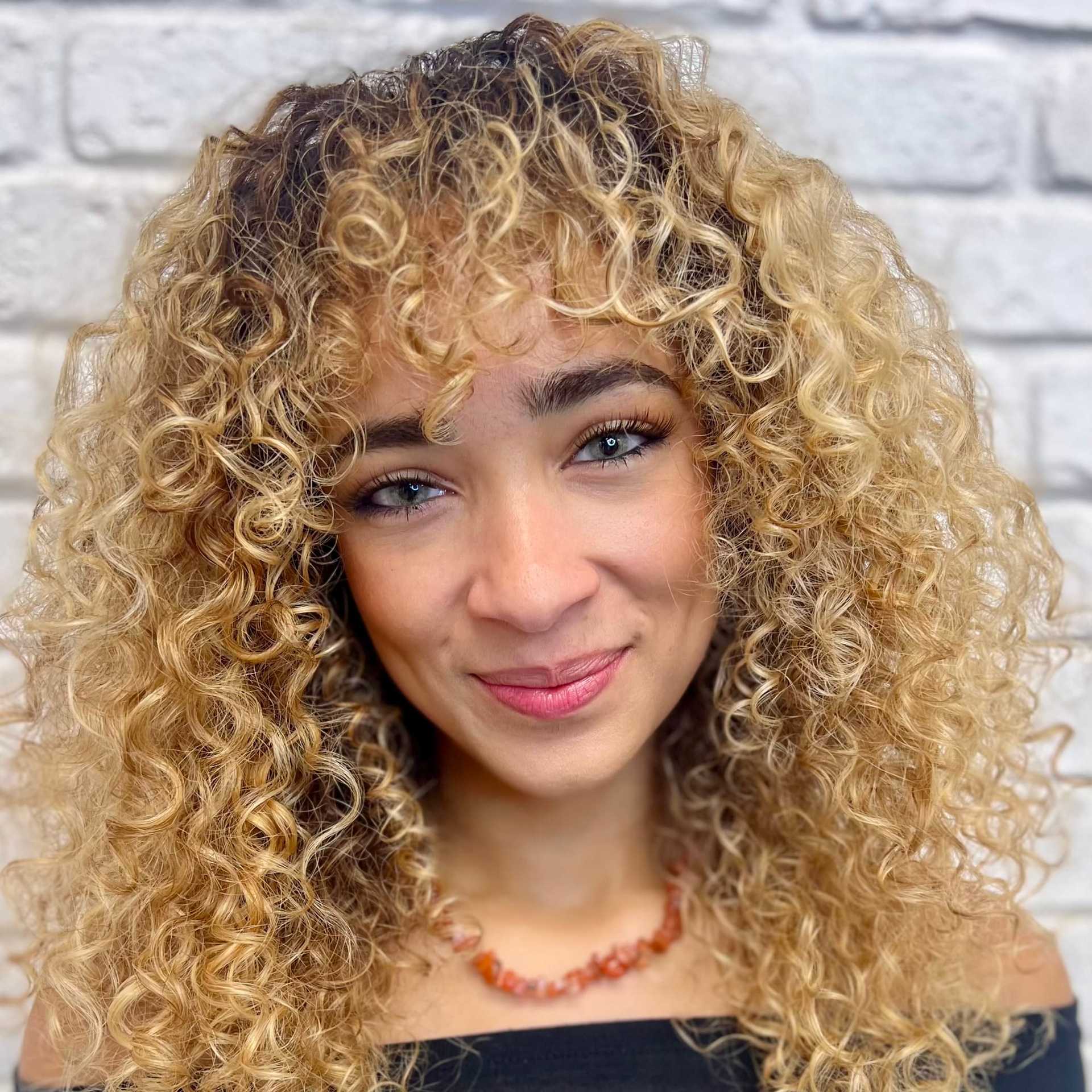 Portrait of Brie, a professional stylist at Hudson Salon, showcasing their expertise and style.