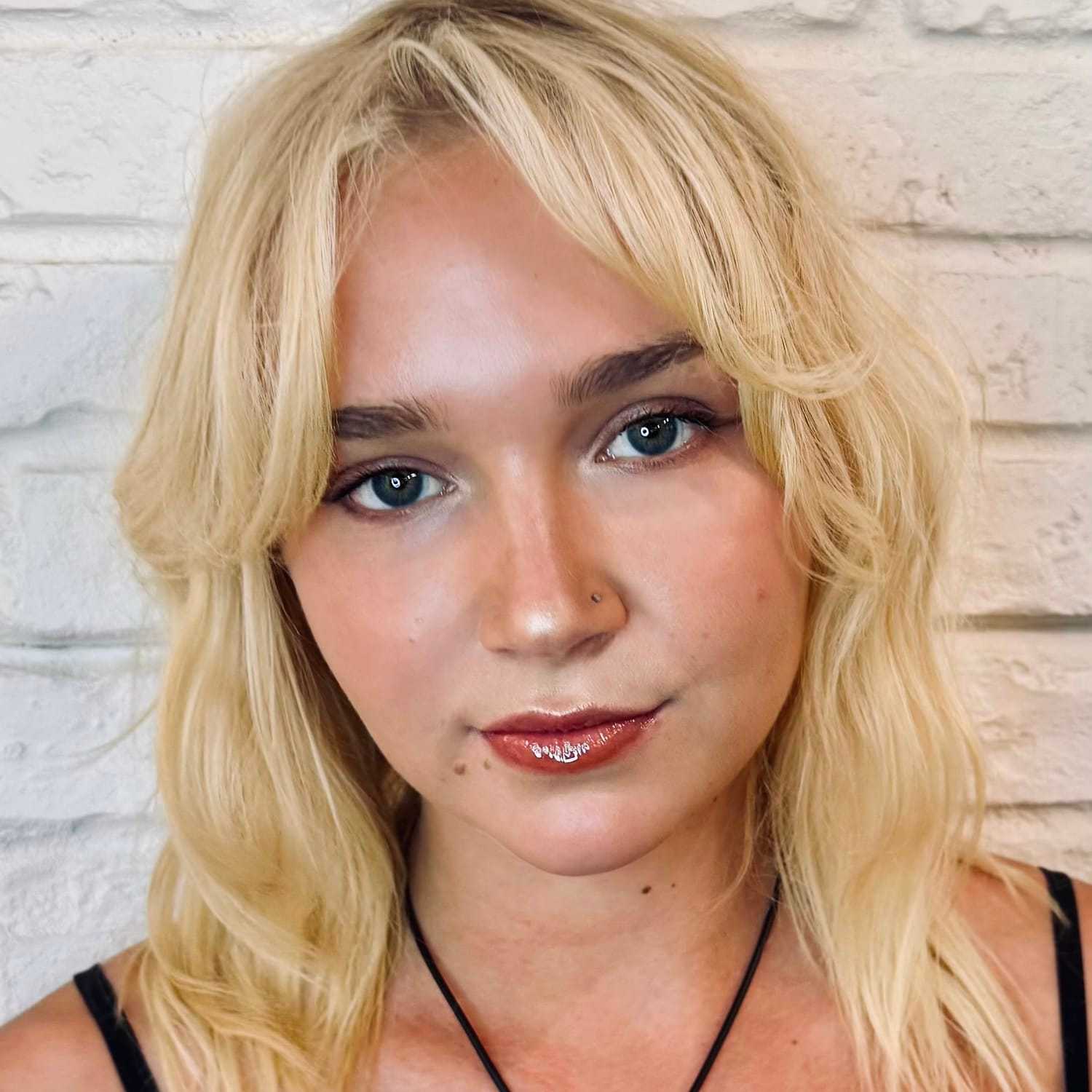 Portrait of Avery, a professional stylist at Hudson Salon, showcasing their expertise and style.