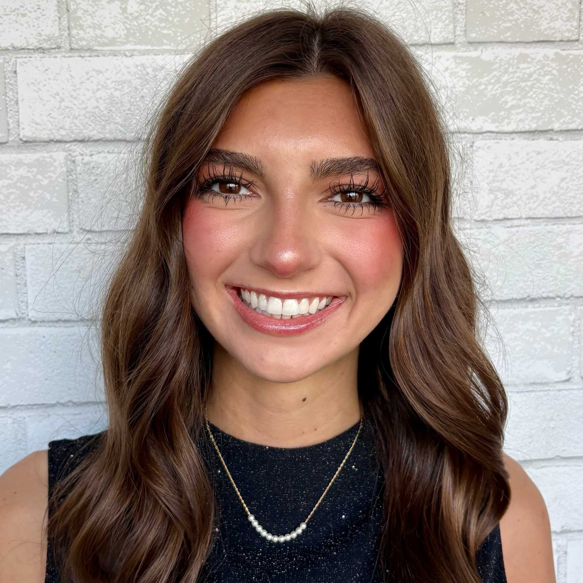 Portrait of Reese, a professional stylist at Hudson Salon, showcasing their expertise and style.