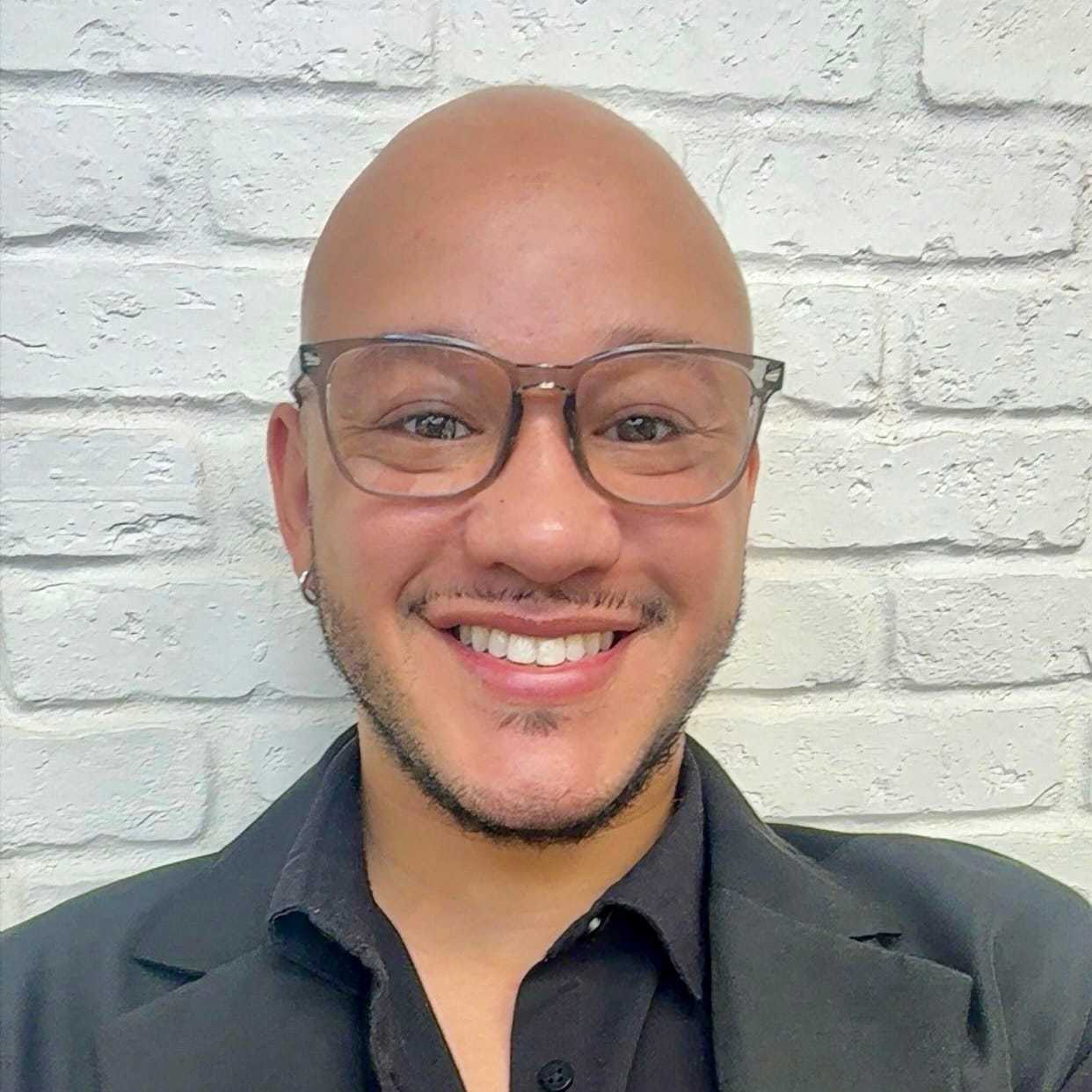 Portrait of Charlie, a professional stylist at Hudson Salon, showcasing their expertise and style.